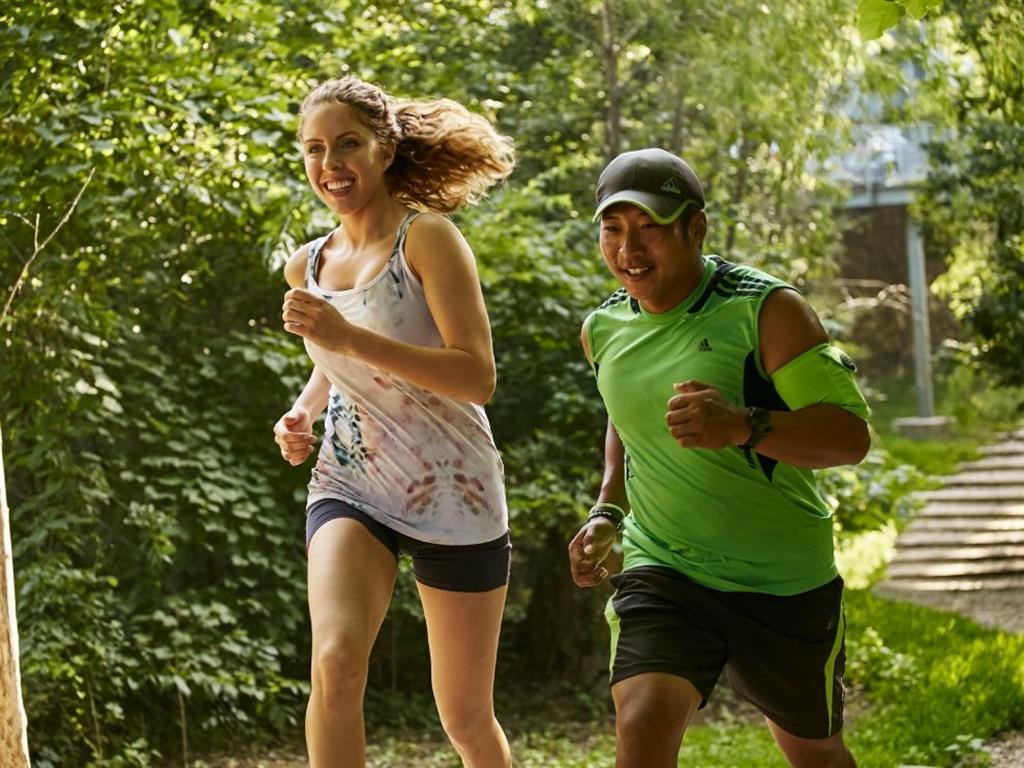 a man and a woman running in the park