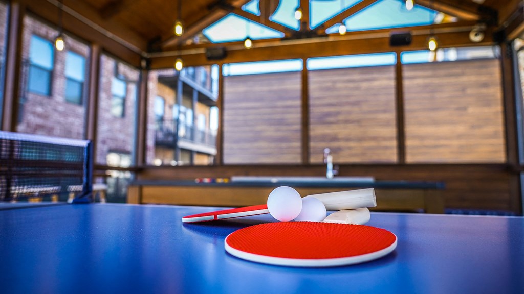 a ping pong paddle and two eggs on a table