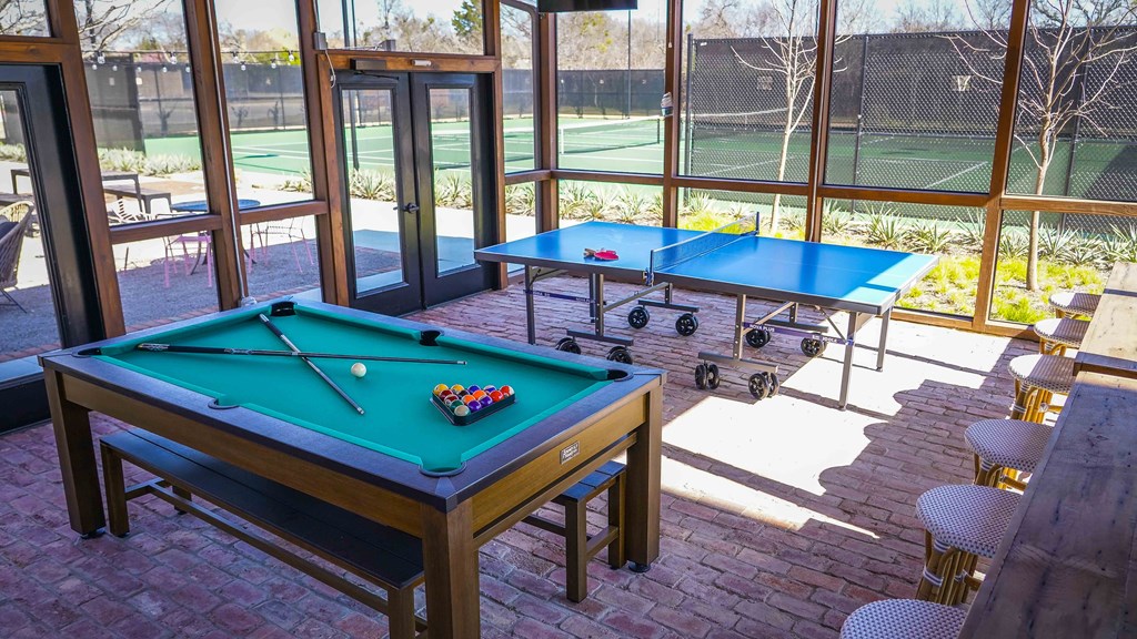 a game room with a pool table and ping pong