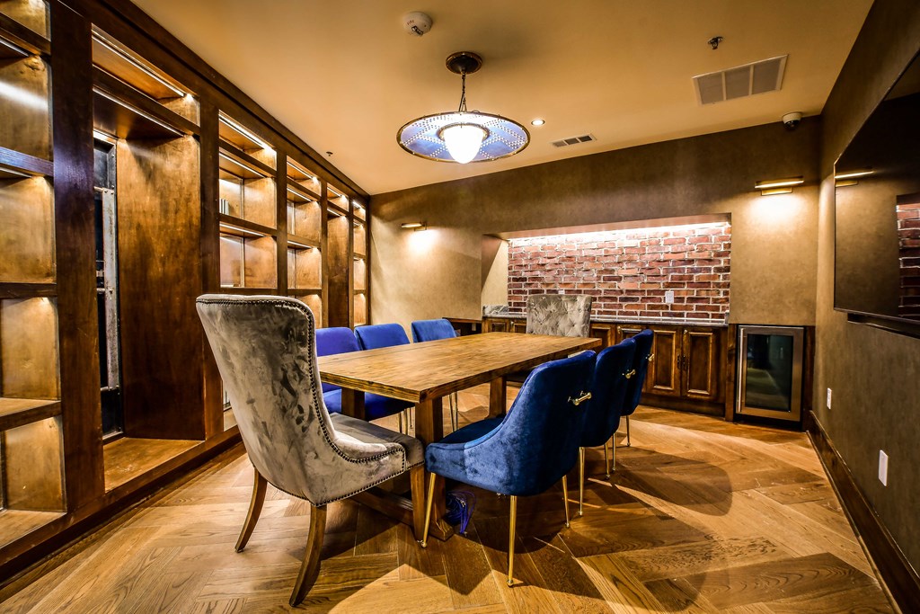 a dining room with a table and chairs and a brick wall