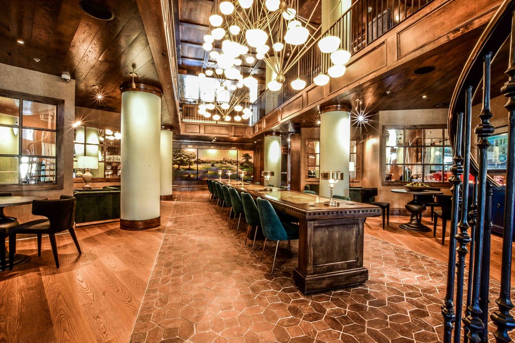 a large restaurant with a long bar and chairs