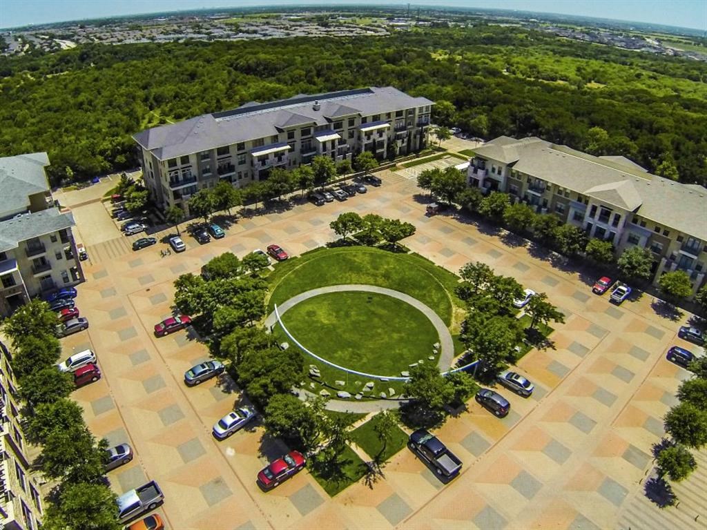 an aerial view of an apartment complex with a green circle in the middle