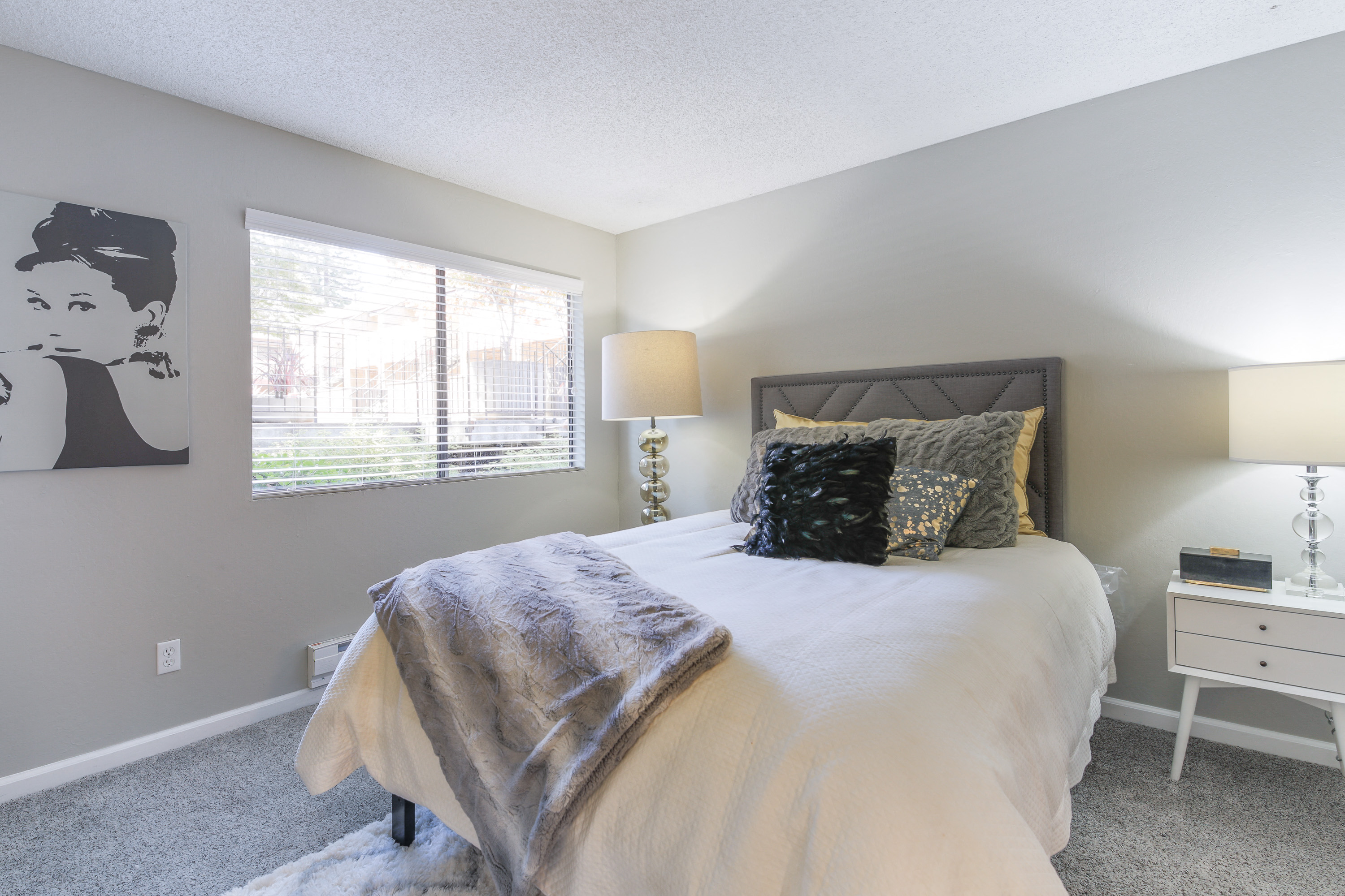 a bedroom with a large bed and a window