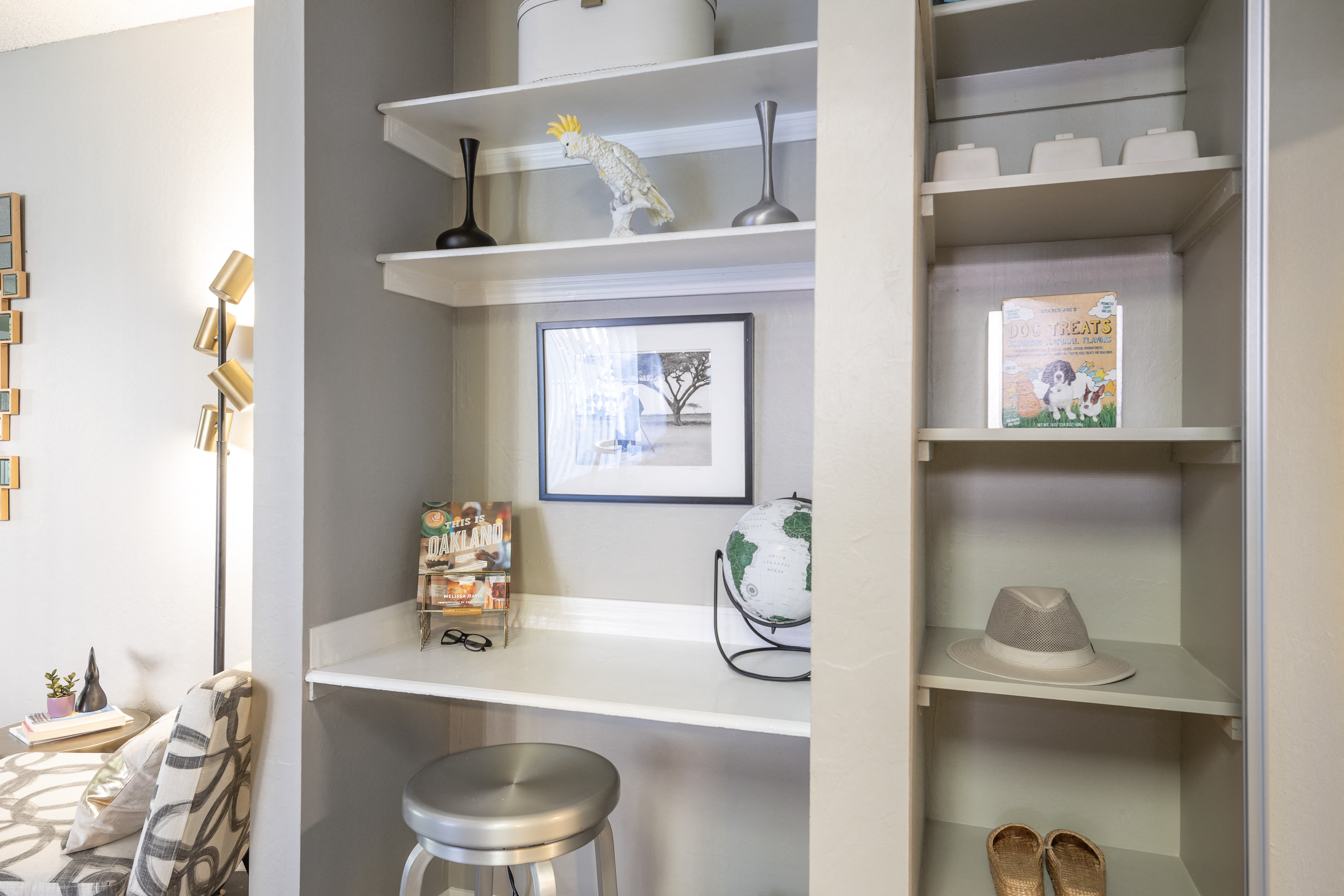 a bookshelf with various items on it and a stool