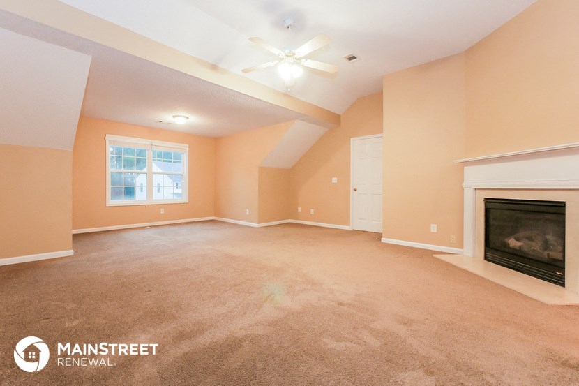 the living room of a home with a fireplace