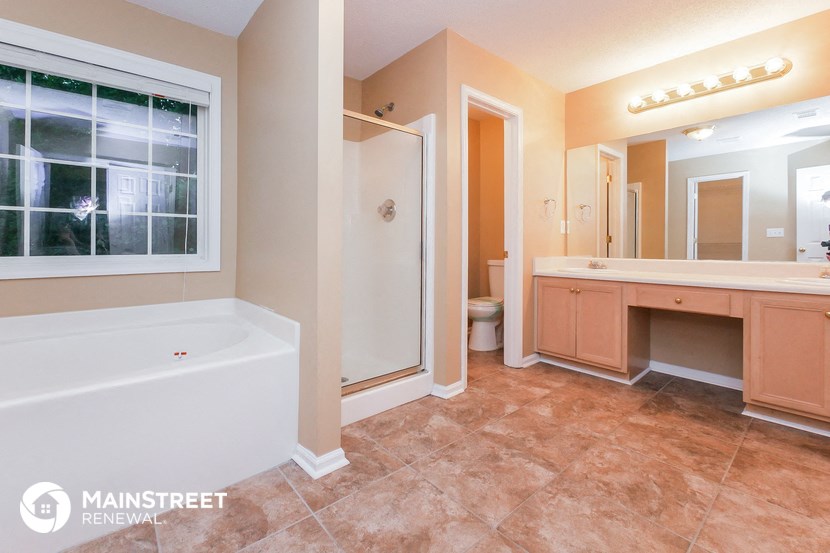 a bathroom with a large tub and a sink and a shower