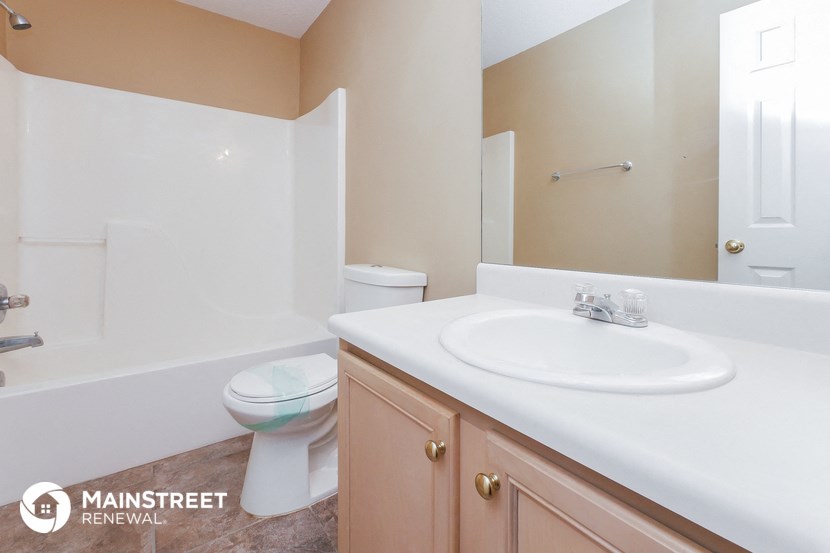 a bathroom with a sink and a toilet and a mirror