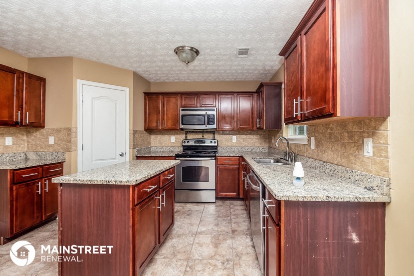 a kitchen with wood cabinets and granite counter tops and a sink
