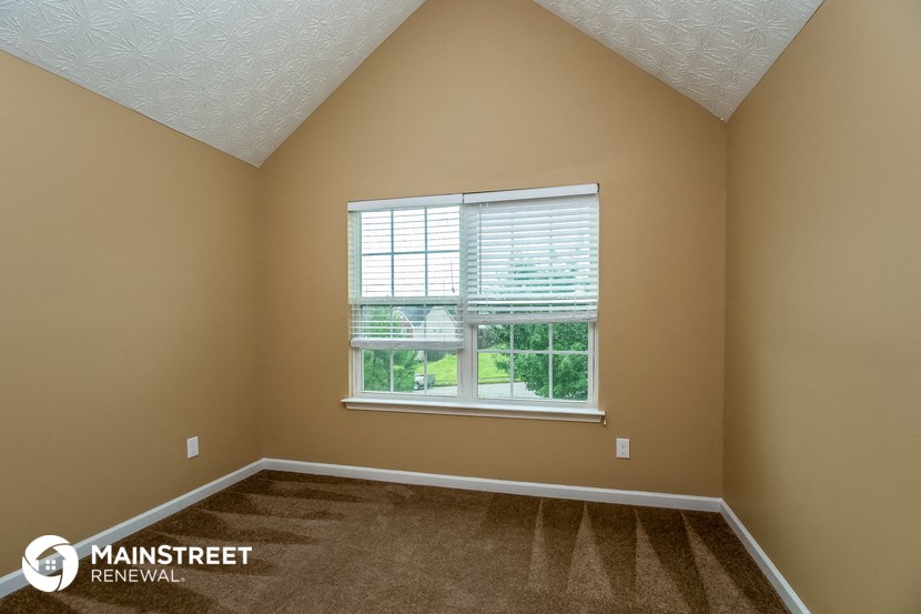 a large window in an empty room with carpet