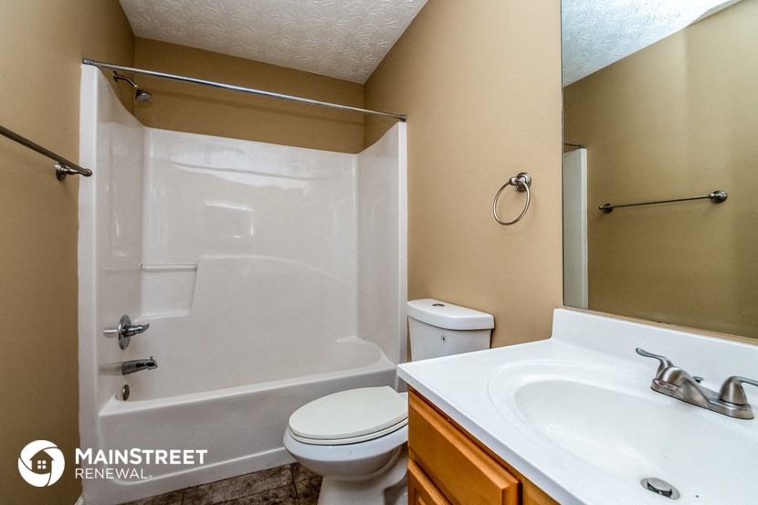 a bathroom with a shower and a sink and a toilet