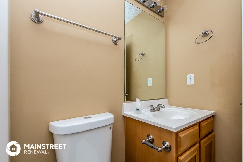 a bathroom with a sink and a mirror and a toilet