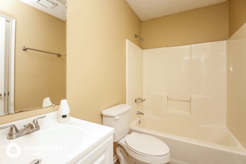 a bathroom with a sink toilet and a bath tub