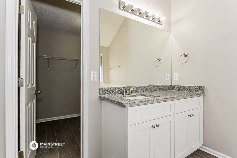 a bathroom with a sink and a mirror