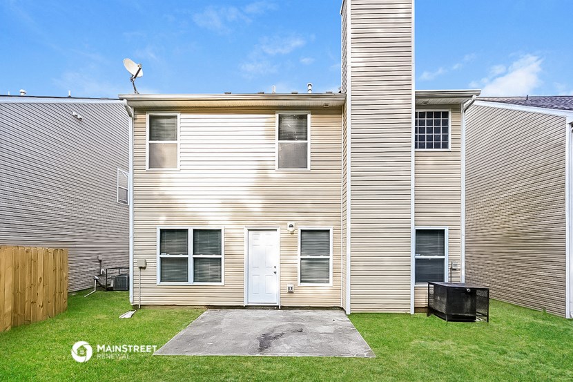 a white apartment building with a white door on the side of it