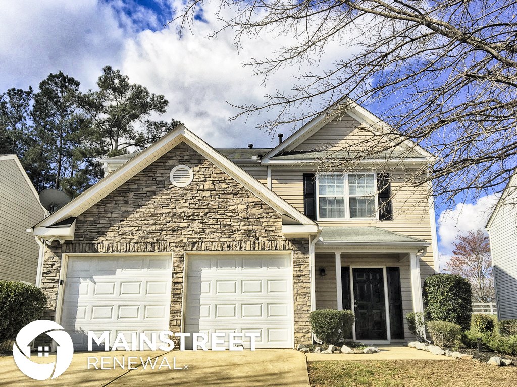 a renovated house with a white garage door