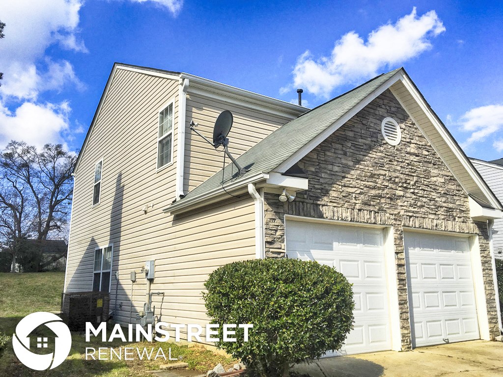 a house with a satellite dish on the side of it