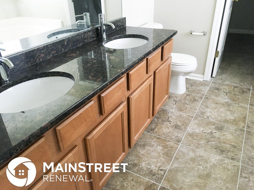 an image of a bathroom with two sinks and a toilet