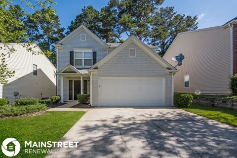 a white and gray house with a garage door