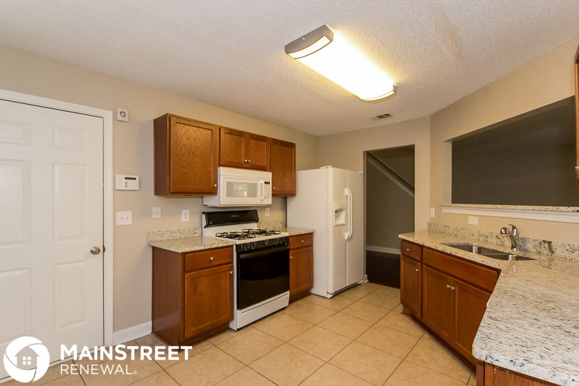a kitchen with a stove and a refrigerator