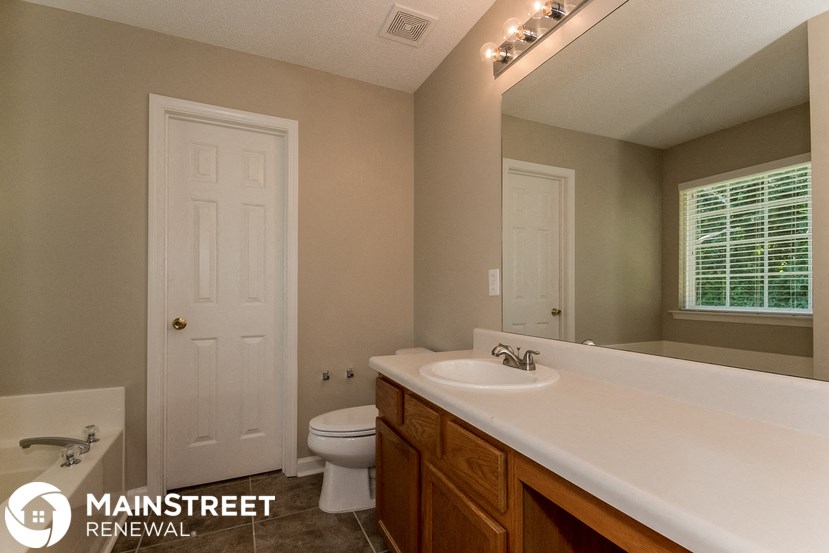 a bathroom with a sink and a toilet and a mirror