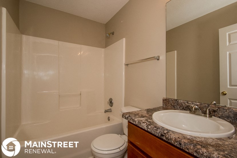 a bathroom with a sink toilet and a shower