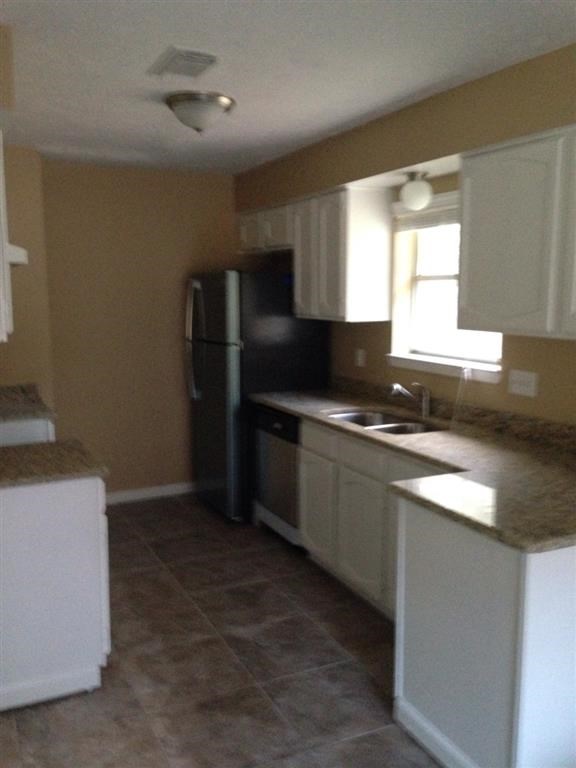 a kitchen with a sink and a refrigerator