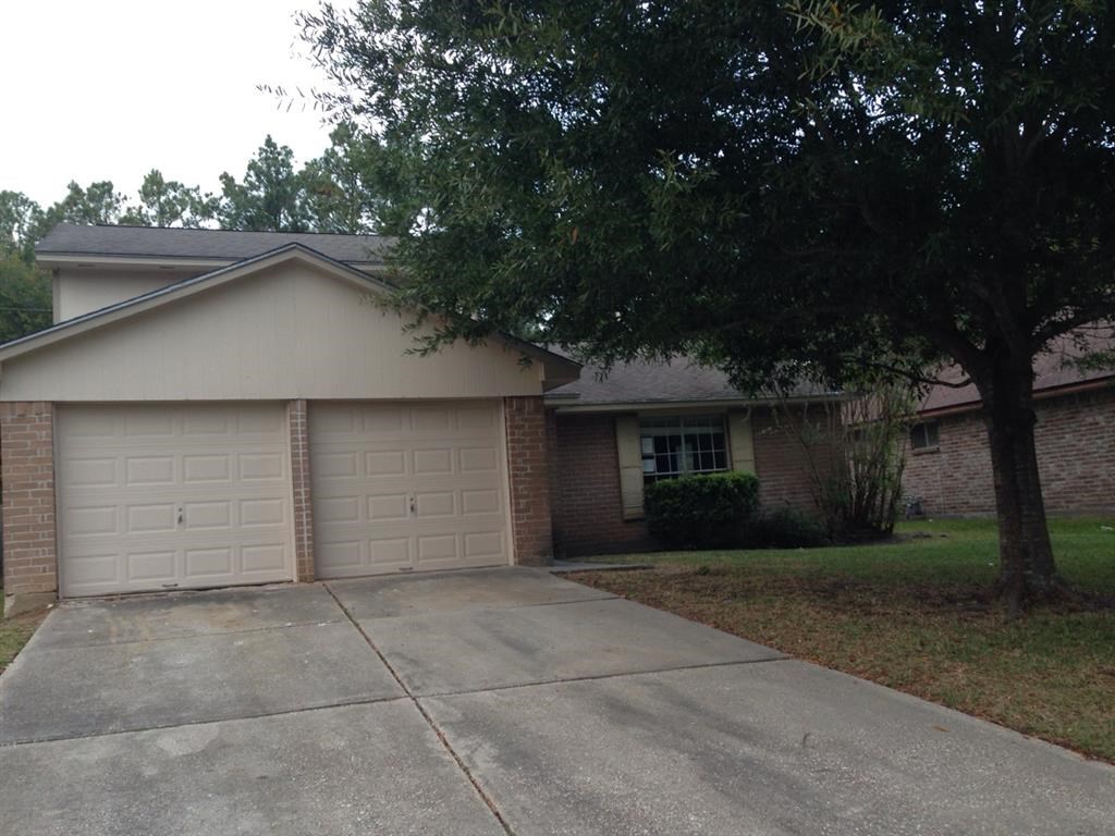 a house with a white garage door and a tree