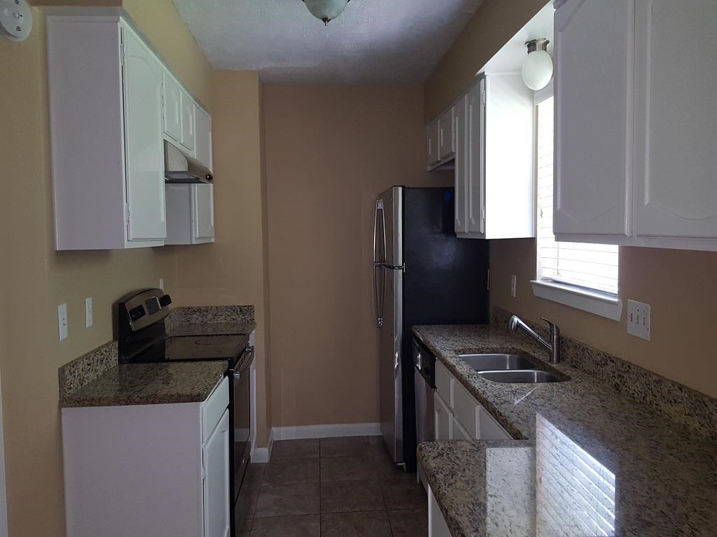 a kitchen with a sink and a refrigerator
