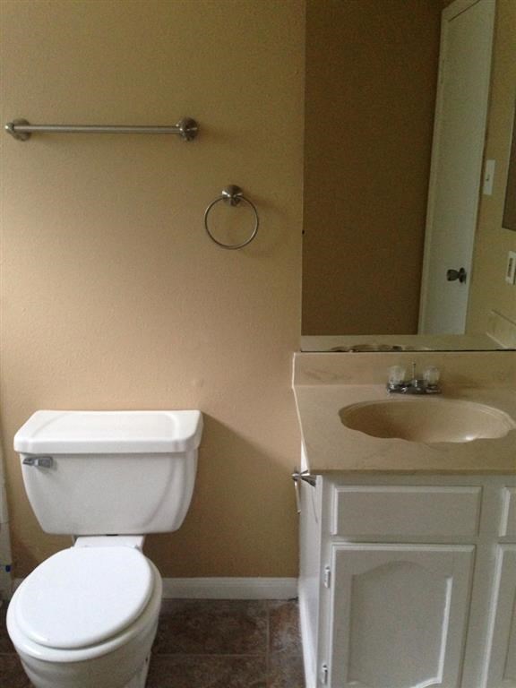 a bathroom with a toilet and a sink and a mirror