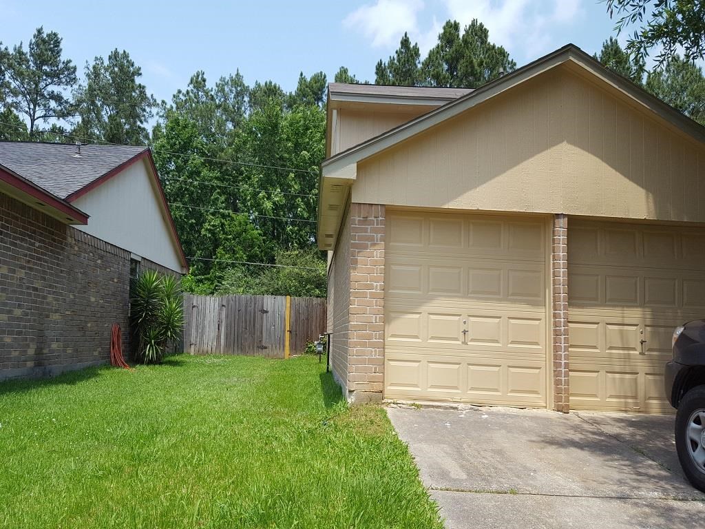 a house with a garage door and a lawn