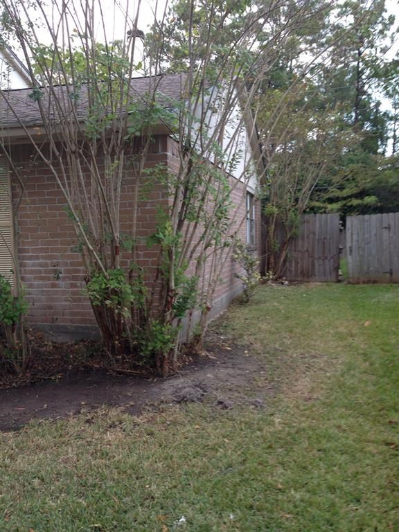 a yard in front of a brick house