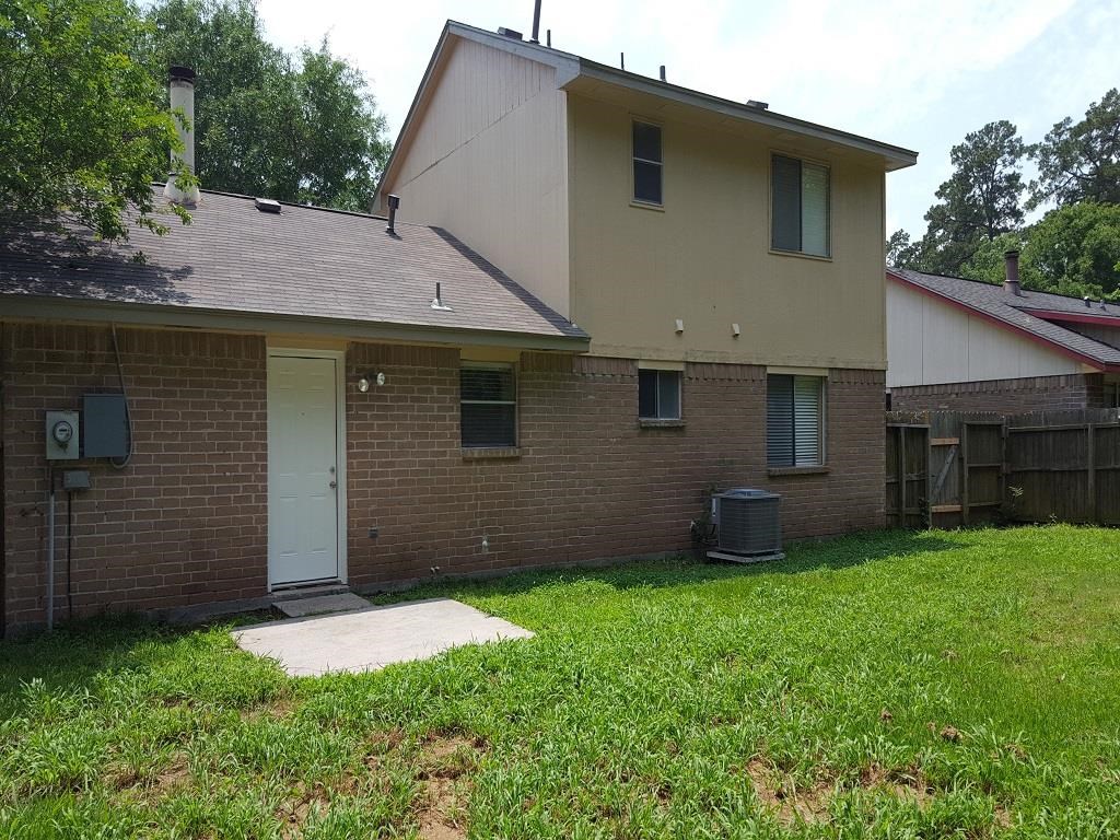 a brick house with a yard and a white door