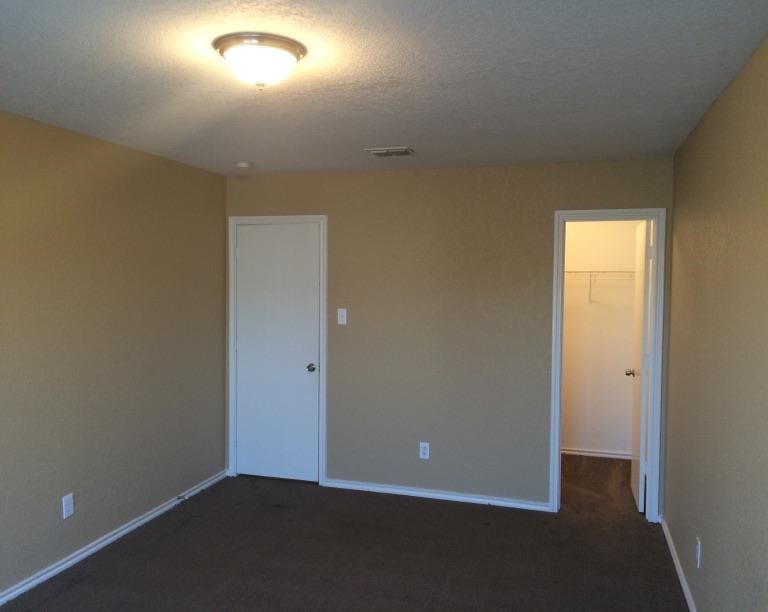 an empty room with a door and a light on the ceiling