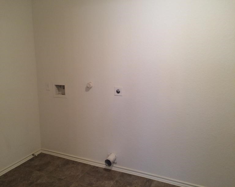 two holes in the wall of a room with toilet paper