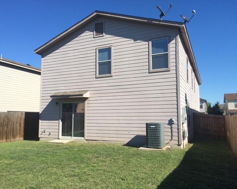 a white house with a yard in front of it