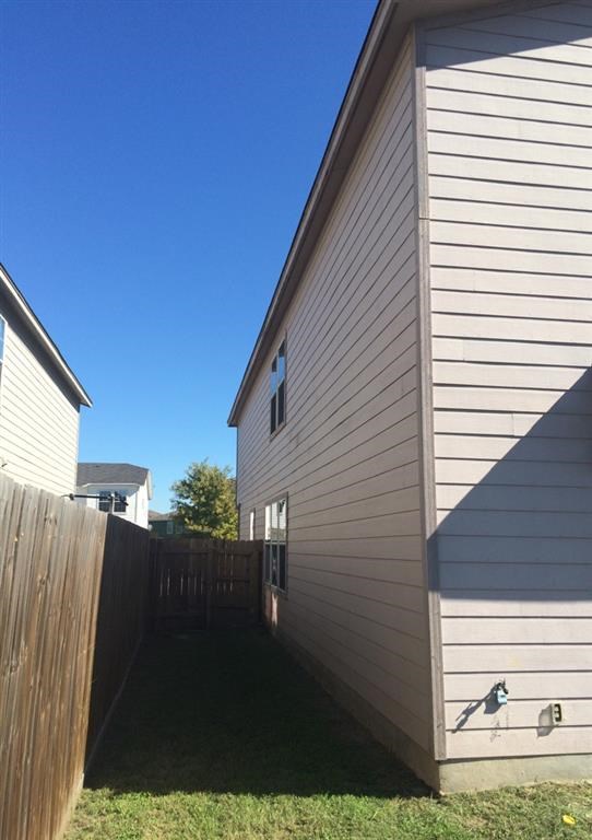 the side of a house with a wooden fence