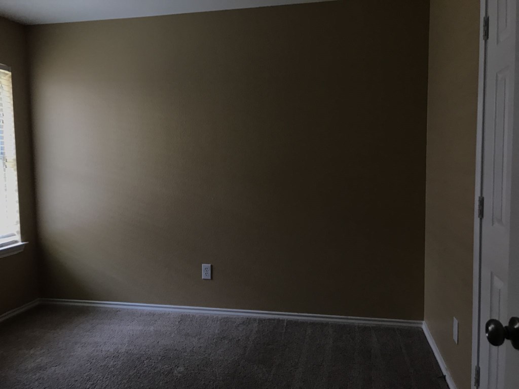 an empty room with a door and a window