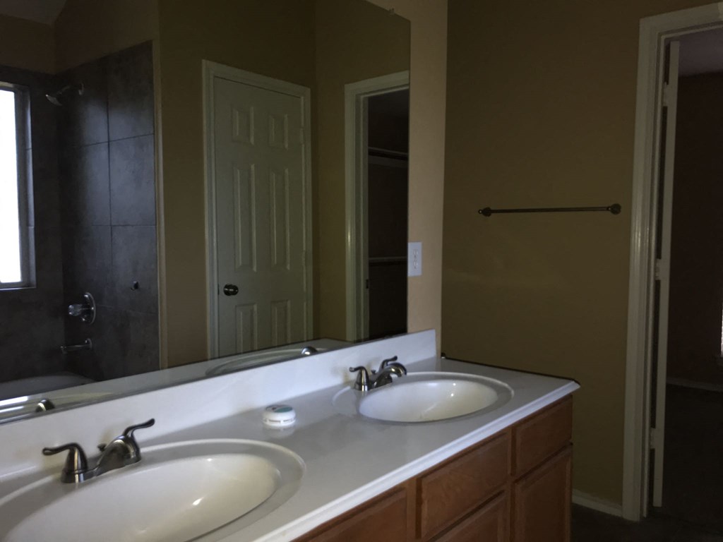 a bathroom with two sinks and a large mirror