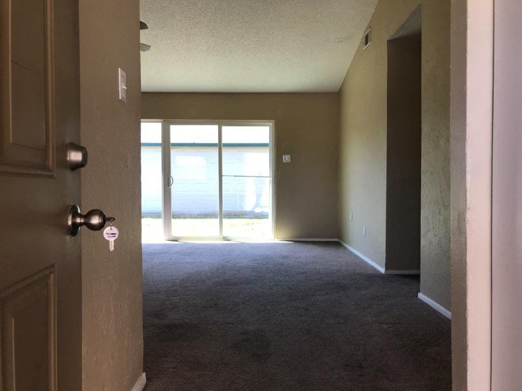 an empty room with a door and a window