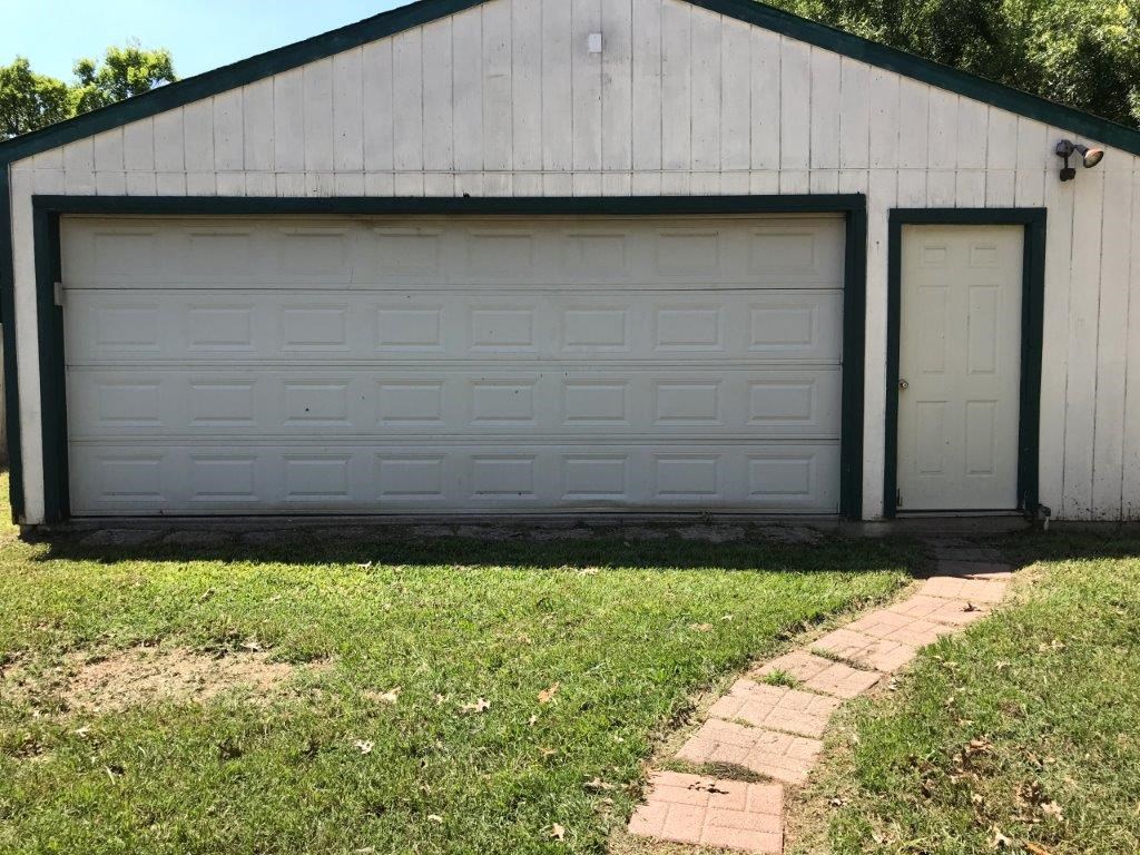 a garage with two garage doors on the side of a building