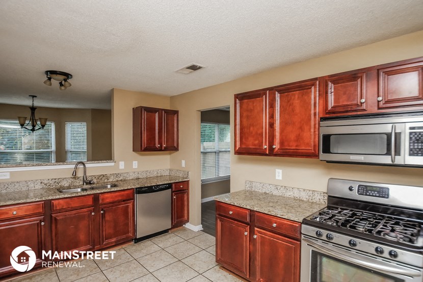 a kitchen with stainless steel appliances and granite counter tops