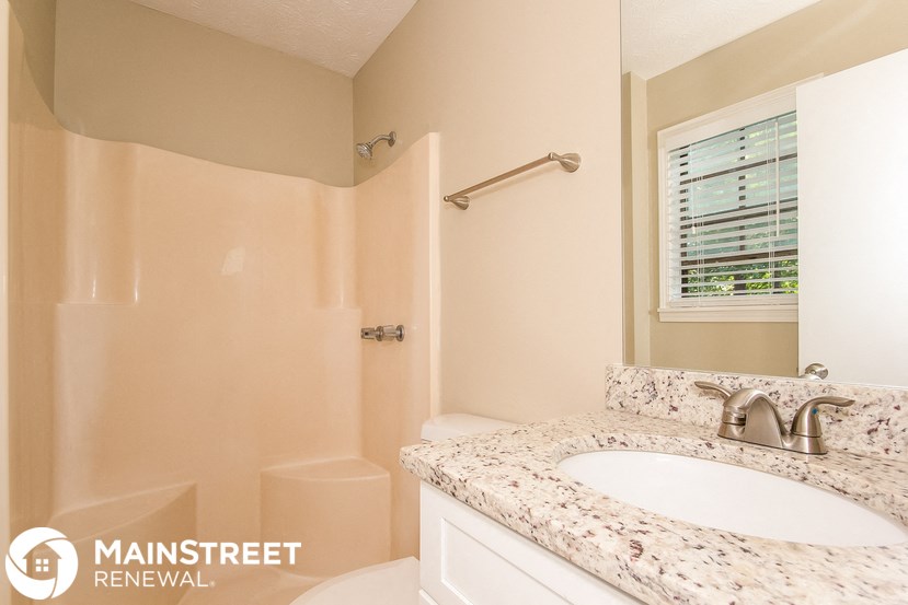 a bathroom with a sink and a toilet and a shower