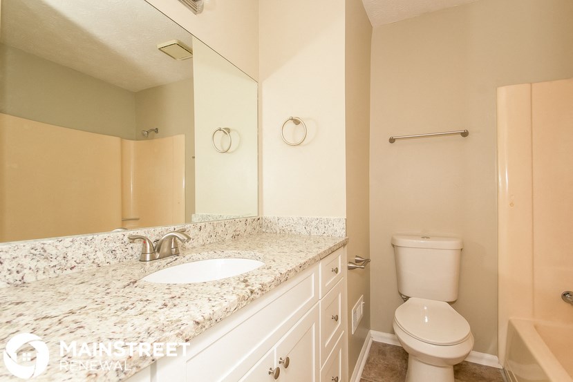 a bathroom with a sink and a toilet and a mirror