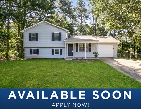 a white house with a lawn and a driveway