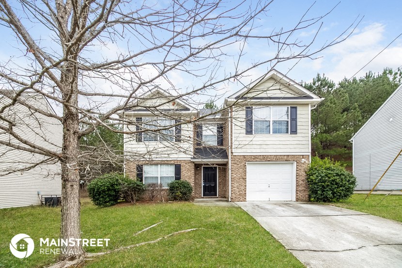 a brick and with a white garage door