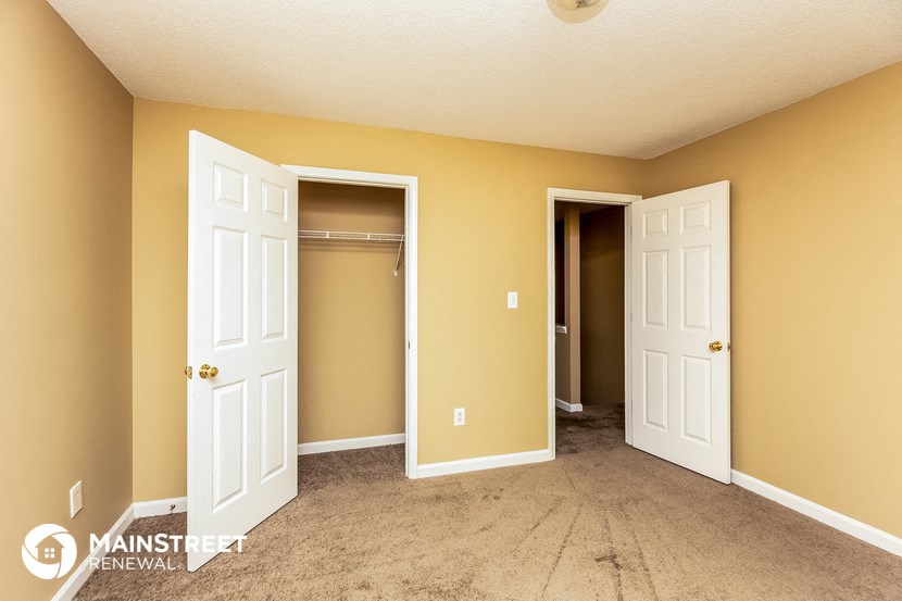 a bedroom with two closets and two doors