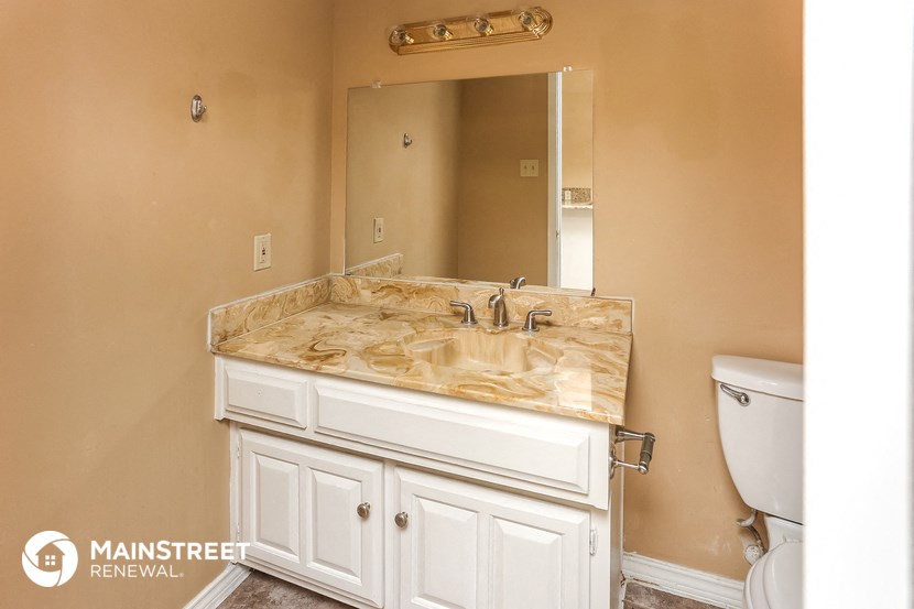 a bathroom with a sink and a toilet and a mirror