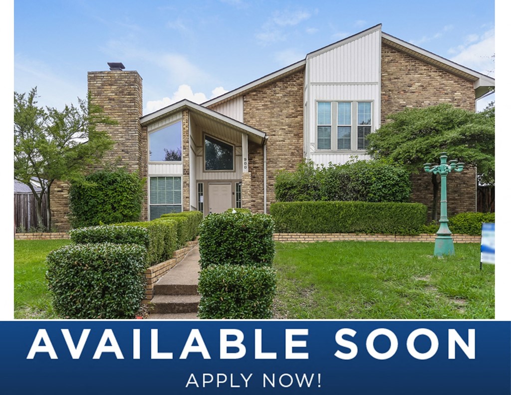 a home with a green yard and a green mailbox