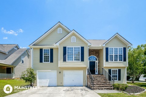 a beige house with a white garage door