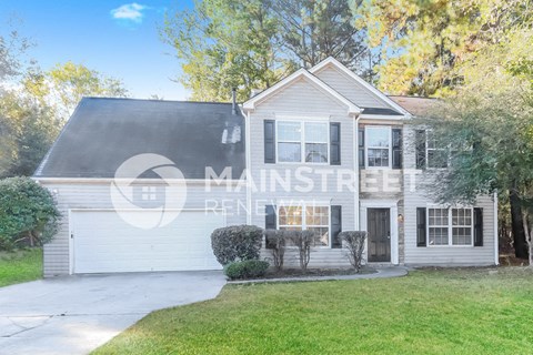 a white house with a white garage and a green lawn